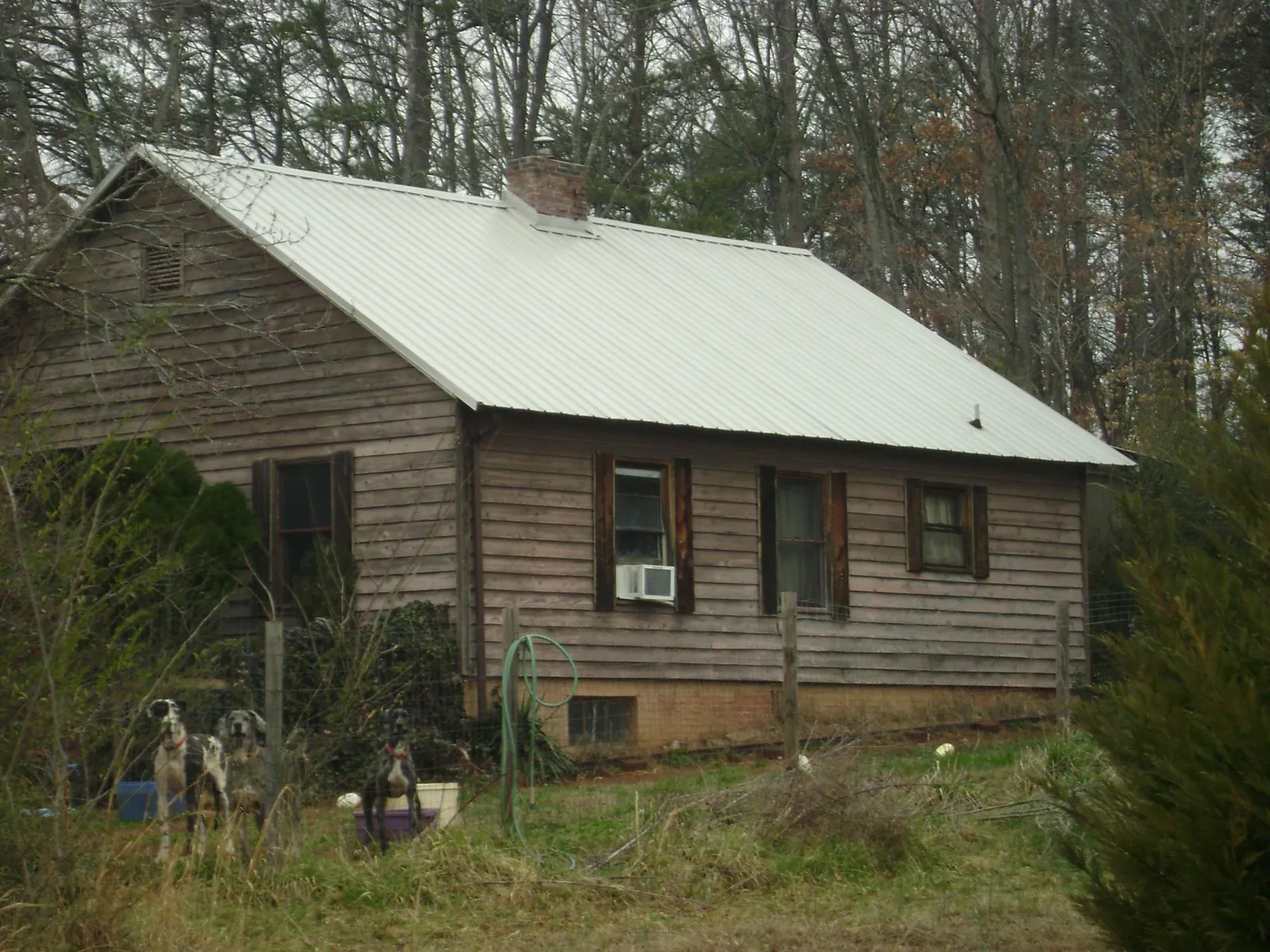 White metal roof on an old wood sided farmhouse, from a Metal Roof Installation job in Susanville